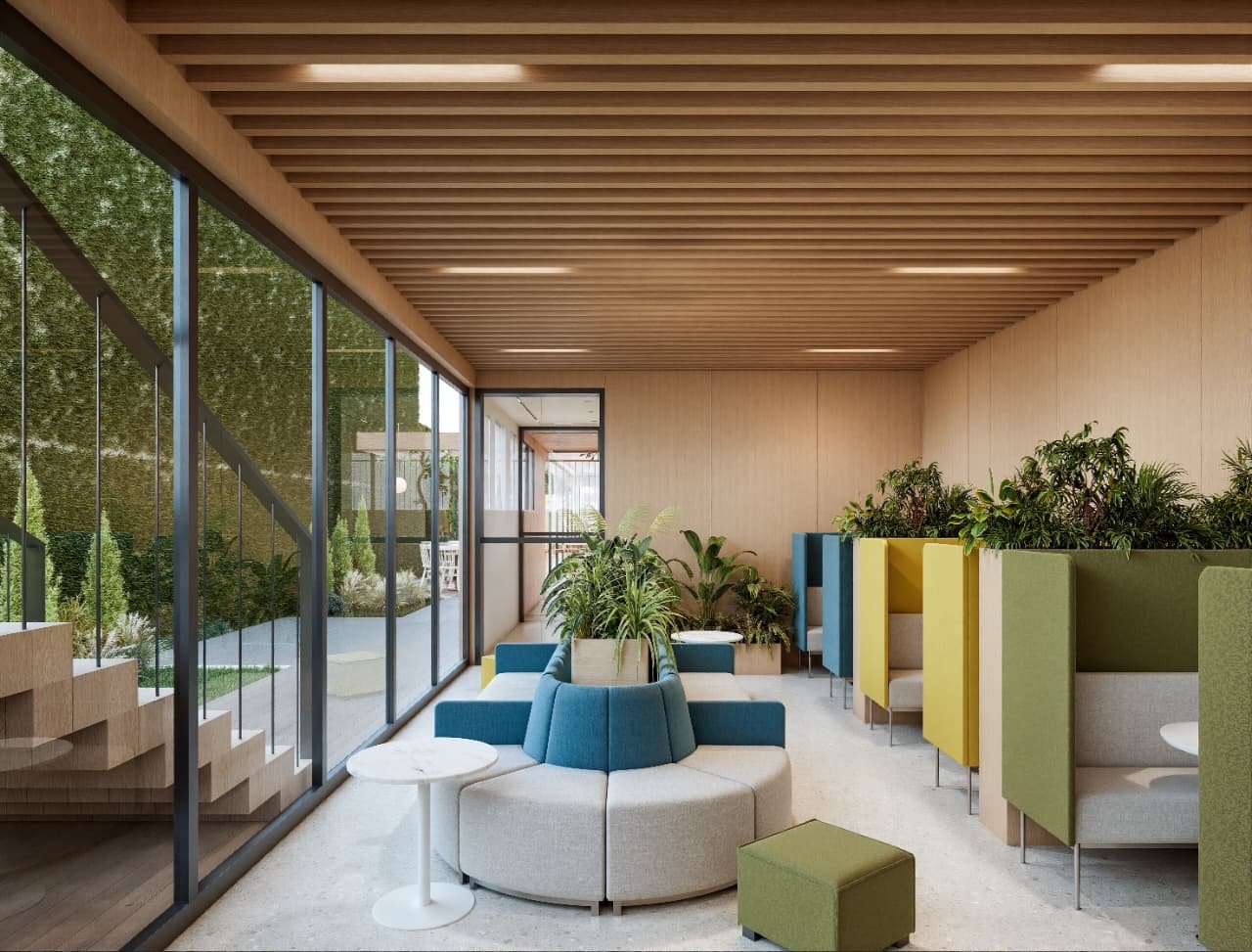 Cowork: cabinas acústicas de colores, isla de estar y muro verde exterior — Tucumán 319